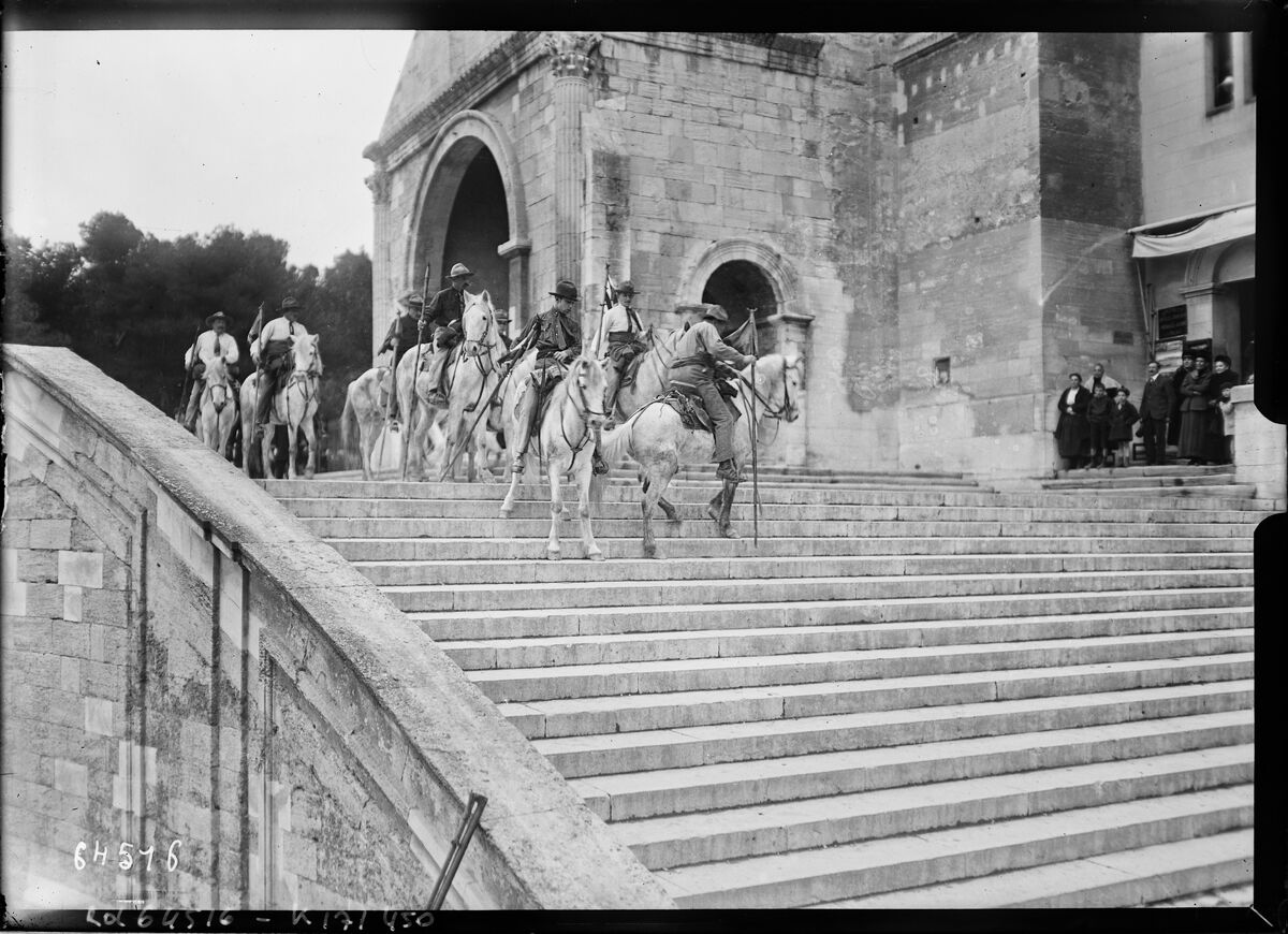 Avignon, visite au château [i. e. Palais] des Papes, [gardians descendant l'escalier du palais, le 15 mars 1921, lors de la visite de M. Millerand] : [photographie de presse] / [Agence Rol]